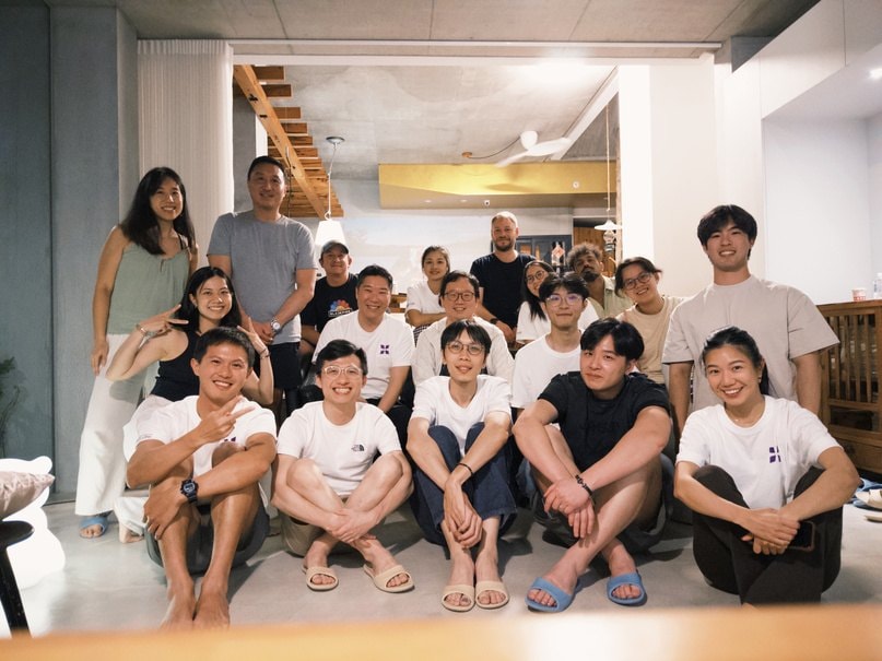The ikigai Launchpad Spring '25 batch gathered on the floor, smiling at the camera